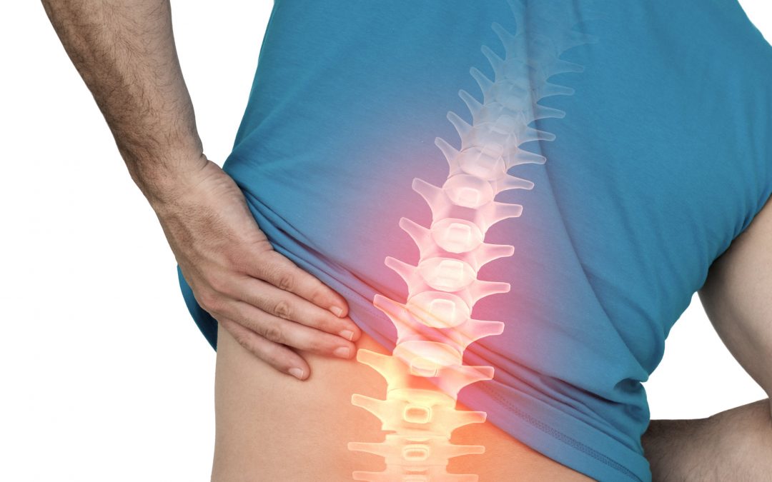 digital composite of highlighted lower spine pain of man